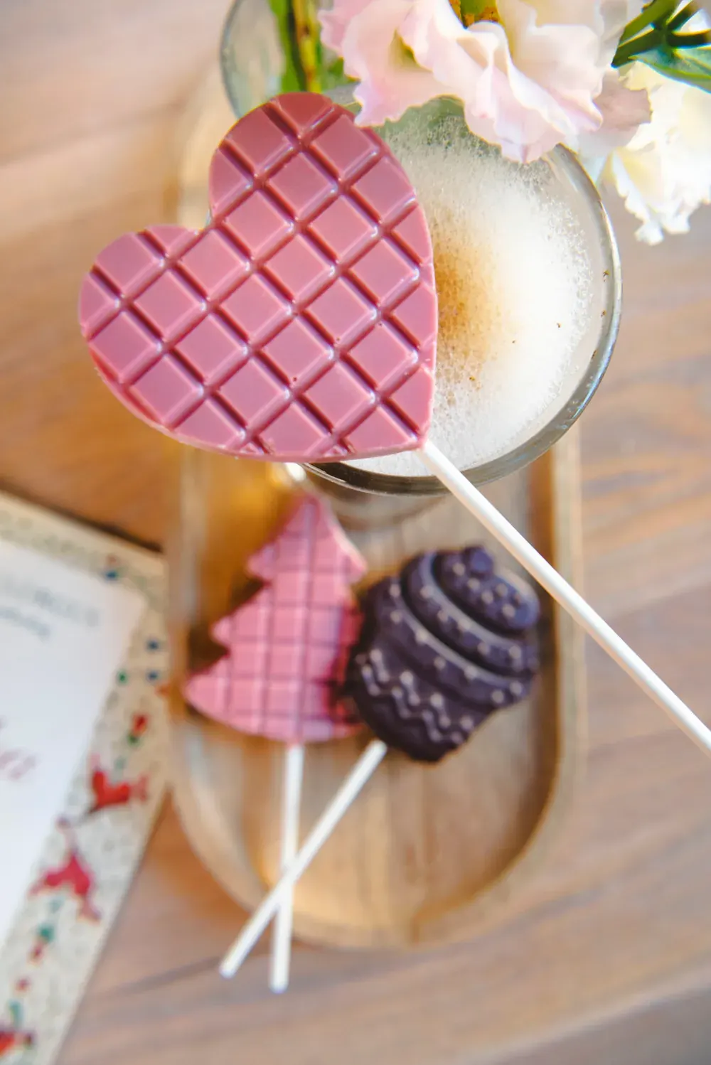 Acadele de ciocolată ruby Choco Toni în formă de inimă și de brăduț, lângă o cafea
